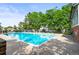 Large community pool surrounded by lush greenery and ample lounge chairs at 943 S Fairplay St, Aurora, CO 80012