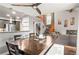Open-concept dining room featuring a modern ceiling fan, wood floors and stairs at 943 S Fairplay St, Aurora, CO 80012