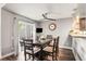 Charming dining room with wood floors, backyard views, and modern ceiling fan at 943 S Fairplay St, Aurora, CO 80012