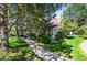 Charming exterior of home with a well-maintained lawn and lovely trees at 943 S Fairplay St, Aurora, CO 80012