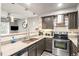 Modern kitchen with stainless steel appliances, granite countertops, and stylish lighting at 943 S Fairplay St, Aurora, CO 80012