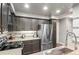 Modern kitchen with stainless steel appliances, granite counters, and ample cabinet space at 943 S Fairplay St, Aurora, CO 80012