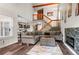 Inviting living room with a modern fireplace, wooden accents, and staircase at 943 S Fairplay St, Aurora, CO 80012