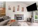 Cozy living room featuring a modern stone fireplace, tv and natural light at 943 S Fairplay St, Aurora, CO 80012