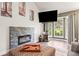 Bright living room with a stone fireplace and a large screen television at 943 S Fairplay St, Aurora, CO 80012