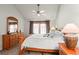 Bright primary bedroom featuring large windows, a ceiling fan, and ample dresser storage at 943 S Fairplay St, Aurora, CO 80012
