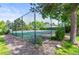 Outdoor community tennis court surrounded by greenery and trees at 943 S Fairplay St, Aurora, CO 80012