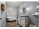 Charming bathroom featuring a clawfoot tub, decorative tile, and vintage-style vanity at 458 Highlands Cir, Erie, CO 80516