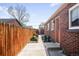 Brick home featuring a backyard with a wooden fence and a storage shed at 3316 N Glencoe St, Denver, CO 80207