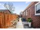 Brick home featuring a cozy backyard with a patio and wooden fence at 3316 N Glencoe St, Denver, CO 80207