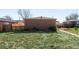 Spacious backyard with lush lawn and mature trees, perfect for outdoor activities at 3316 N Glencoe St, Denver, CO 80207