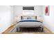 Bright bedroom featuring a neutral color palette, a decorative rug and modern art accents at 3316 N Glencoe St, Denver, CO 80207
