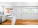 Bright entryway with hardwood floors, marble breakfast bar and white paint at 3316 N Glencoe St, Denver, CO 80207