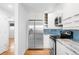 Modern kitchen featuring stainless steel appliances and white cabinets at 3316 N Glencoe St, Denver, CO 80207