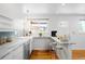 Bright kitchen with white cabinets, breakfast bar, and modern decor at 3316 N Glencoe St, Denver, CO 80207
