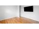 Bright living room featuring gleaming hardwood floors, large windows and built-in shelving at 3316 N Glencoe St, Denver, CO 80207