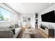 Bright living room with hardwood floors, large window, and stylish furnishings at 3316 N Glencoe St, Denver, CO 80207