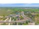 Aerial view shows the property situated among lush greenery, a golf course, and other beautiful homes in the neighborhood at 8655 E 130Th Ave, Thornton, CO 80602
