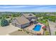 Beautiful aerial view of a home with a three-car garage, covered patio, pool, and lush landscaping at 8655 E 130Th Ave, Thornton, CO 80602