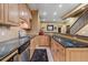 Wet bar area with granite countertops, wine rack, stainless steel dishwasher, and classic design elements at 8655 E 130Th Ave, Thornton, CO 80602