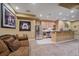 Basement featuring wet bar with stainless steel appliances, comfortable sofa, and sports memorabilia at 8655 E 130Th Ave, Thornton, CO 80602