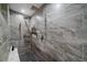 Walk-in shower with dual shower heads, stone tiling, and a built-in shower niche at 8655 E 130Th Ave, Thornton, CO 80602
