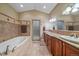 Spa-like bathroom with a jacuzzi tub, walk-in shower, and double vanity at 8655 E 130Th Ave, Thornton, CO 80602