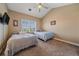 Cozy bedroom with two twin beds, plush carpeting, and window with wooden shutters at 8655 E 130Th Ave, Thornton, CO 80602