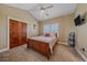 Comfortable bedroom with a ceiling fan, window with wooden shutters, and a closet at 8655 E 130Th Ave, Thornton, CO 80602