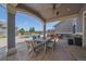 Comfortable covered patio with a ceiling fan, dining table, barbecue area, and a view of the pool at 8655 E 130Th Ave, Thornton, CO 80602