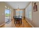 Bright dining room with hardwood floors, large windows, and a sliding door to the outdoors at 8655 E 130Th Ave, Thornton, CO 80602