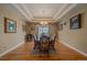 Elegant dining room featuring hardwood floors, tray ceiling, and ample natural light at 8655 E 130Th Ave, Thornton, CO 80602
