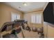 A home exercise room featuring a treadmill, stationary bike, TV and fitness equipment at 8655 E 130Th Ave, Thornton, CO 80602