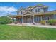 Charming home showcasing a covered front porch with stone accents and a well-kept lawn at 8655 E 130Th Ave, Thornton, CO 80602