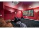 Comfortable home theater featuring a projector, large screen, and cozy seating with bean bags and reclining sofa at 8655 E 130Th Ave, Thornton, CO 80602