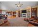 Spacious living room featuring a cozy fireplace, large tv, and comfortable leather furniture at 8655 E 130Th Ave, Thornton, CO 80602