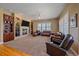 Spacious living room with a fireplace, and built-in shelving at 8655 E 130Th Ave, Thornton, CO 80602
