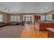 Open-concept living area with hardwood floors and a kitchen island at 8655 E 130Th Ave, Thornton, CO 80602