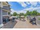 Backyard patio boasts an outdoor bar, BBQ grill, seating around a fire pit, and a beautiful yard at 8655 E 130Th Ave, Thornton, CO 80602