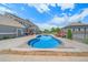 Inviting backyard pool with lounge chairs, barbecue, hot tub, and a covered patio area perfect for entertaining at 8655 E 130Th Ave, Thornton, CO 80602