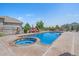 Beautiful swimming pool with built-in hot tub and patio area with lounge chairs in landscaped backyard at 8655 E 130Th Ave, Thornton, CO 80602