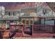 A cozy back porch with a maroon wood fence and doors that lead into the house at 5252 W 68Th Ave, Arvada, CO 80003