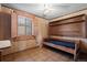 Small bedroom with wood paneling, a built-in bed, and a window with shutters at 5050 Steele St, Denver, CO 80216