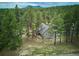 Aerial view of a home nestled amongst lush trees at 7312 Marshall Rd, Larkspur, CO 80118