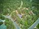 Aerial view of a home nestled among lush trees in a serene neighborhood at 7312 Marshall Rd, Larkspur, CO 80118
