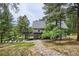Beautiful backyard with large deck, seating area, and rock-lined path leading to the home at 7312 Marshall Rd, Larkspur, CO 80118