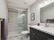 Modern bathroom features a glass enclosed shower, hexagon shower floor tiles and gray vanity at 7312 Marshall Rd, Larkspur, CO 80118