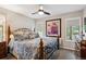 Inviting bedroom featuring a decorative bed frame, plush bedding, and natural lighting at 7312 Marshall Rd, Larkspur, CO 80118