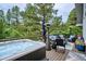 Relax on this deck with a hot tub and seating area, perfect for entertaining guests at 7312 Marshall Rd, Larkspur, CO 80118