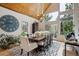 Elegant dining area features a large window, wood ceiling, modern lighting, and stylish decor at 7312 Marshall Rd, Larkspur, CO 80118